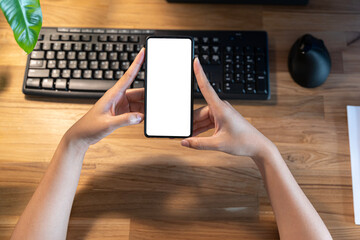 Woman holding smartphone with blank screen. Cropped shot of a businesswoman using a mobile phone...