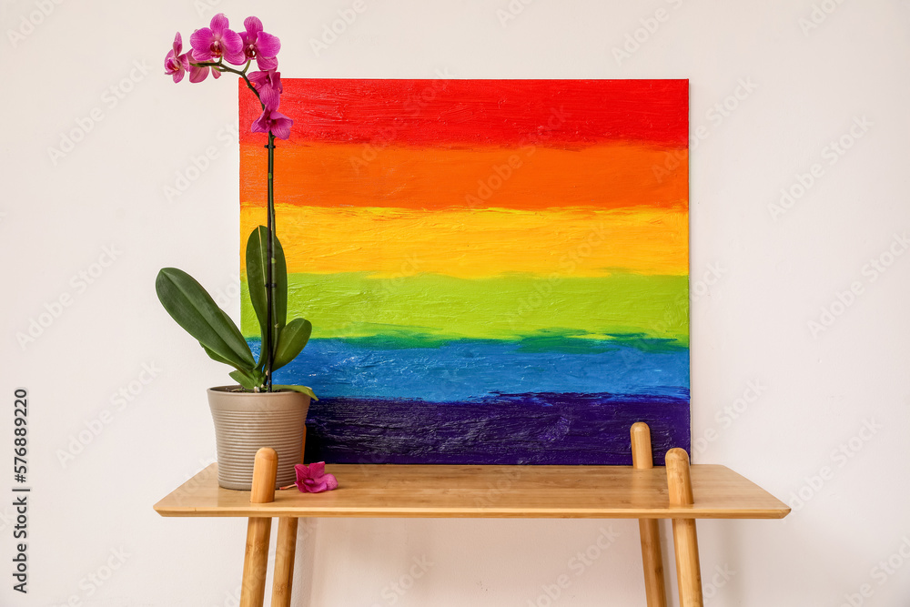 Poster Painting of LGBT flag and flower on shelf near light wall