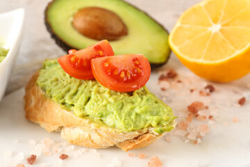 Delicious avocado toast with tomatoes on board, closeup