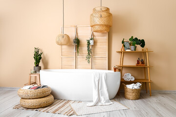 Interior of bathroom with bathtub, houseplants and folding screen - obrazy, fototapety, plakaty