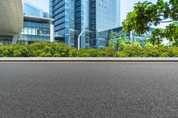Obraz na płótnie Canvas Empty asphalt road through modern city in Shanghai, China.