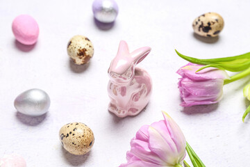 Obraz na płótnie Canvas Bunny, Easter quail eggs and tulip flowers on white background