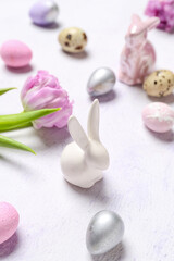 Obraz na płótnie Canvas Bunny, Easter quail eggs and tulip flower on white background