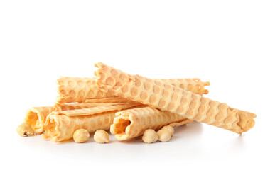 Delicious wafer rolls and hazelnuts isolated on white background