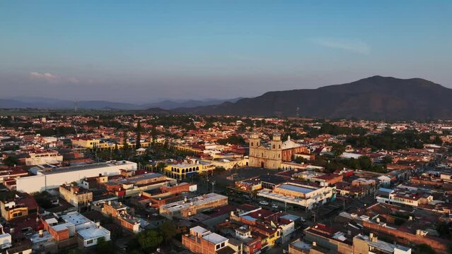 Flying Towards The City Centre Square With Tuxpan Church In Jalisco, Mexico. Aerial Drone Shot