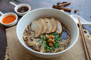 Duck Noodles soup - Braised of duck noodles in white bowl of wood table at close up view, Asian food