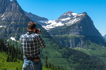 Tourist man taking pictures in Glacier National Park in Montana