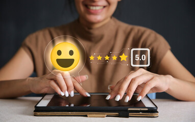 Close up of man hand pressing on smartphone screen with gold five star rating and press level...