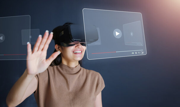 Young Woman Wear VR Headset Standing And Watch Movie At Night.