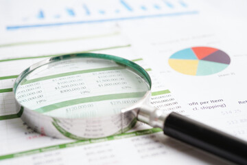 Magnifying glass on charts graphs paper. Financial development, Banking Account, Statistics,...