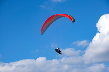 Paramotor sport. man driving a paramotor See the beautiful scenery cloudy sky background extreme sports concept