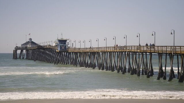 Imperial Beach Pier in Southern California with waves during a sunny day - slow motion