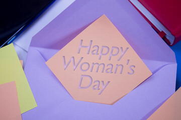 Happy Woman's Day. Text on adhesive note paper. Event, celebration reminder message.