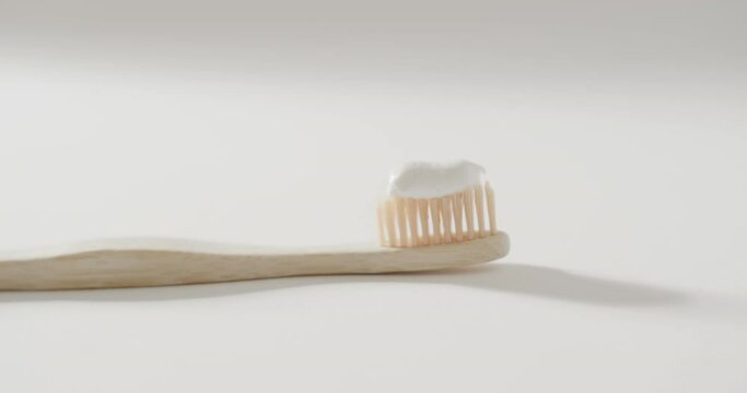 Close up of toothbrush with toothpaste on white background with copy space