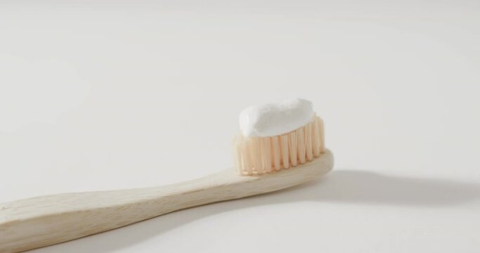 Close up of toothbrush with toothpaste on white background with copy space
