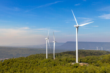 Wind turbines farm on mountanis landscape at Lam Takong Reservoir Views against blue sky with clouds background,Windmills for electric power ecology concept