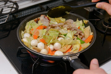 フライパンで炒める調理シーン