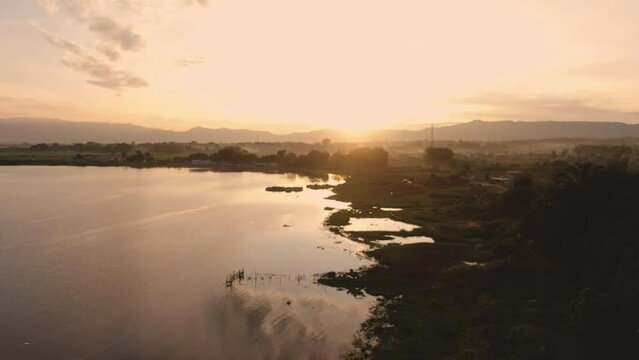 Aerial View of Sunrise on Lake Toba's Bul Bul Beach, Balige, Toba Regency. You can see beautiful views of Lake Toba and expanses of rice fields and residential areas