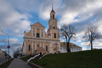 Fototapeta na wymiar The Church of the Finding of the Holy Cross (an active Catholic church) and the Bernardine Monastery on a sunny day, Grodno, Belarus