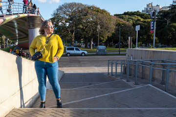 Latin plus size female model wearing sunglasses and posing with confident in the city. Copy space. Real Woman Empowerment- Body Positive concept. 