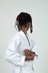 Portrait on studio of latin teen with braids practicing Martial arts on workout in white background isolated