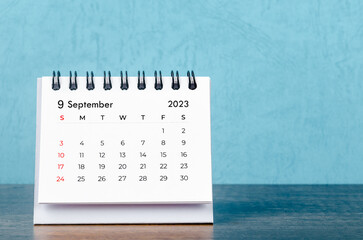 The September 2023 desk calendar on blue color background, Vintage style.
