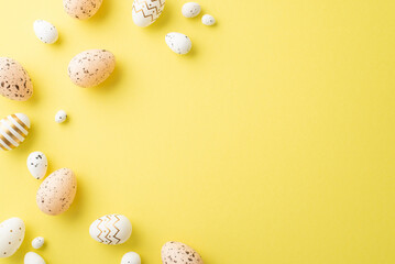 Easter decorations concept. Top view photo of light pink white and gold quail eggs on isolated yellow background with empty space