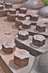 Close up of rusted bolts on an old electrical generating station.