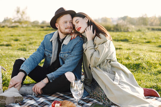 Stylish couple have a picnic on a nature and hugging