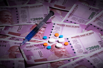 Medicine and injection with indian money, expensive treatment of medical insurance concept