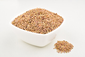 Carom seed in bowl on white background, indian spice