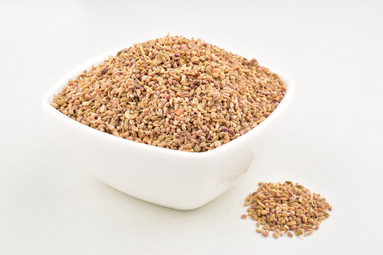 Carom seed in bowl on white background, indian spice