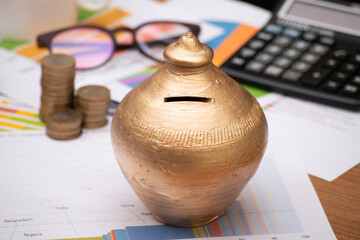 Indian piggy bank or gullak at office table, long term savings concept