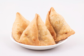 Samosas in plate on white background, asian snack food