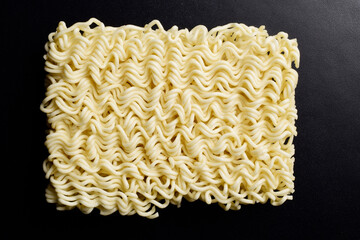 Top view of uncooked noodle on dark background