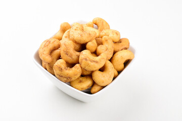 Spicy Cashew nuts in bowl on white background