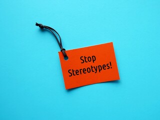 Orange tag on blue background with text message - STOP STEREOTYPES! -  to stop stereotypes or...