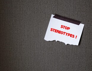 White torn paper stick on office wall background with text message - STOP STEREOTYPES!  to stop...