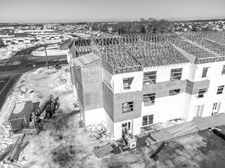 Aerial drone view of a multifamily apartment complex under construction.