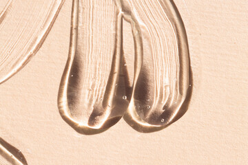 Samples of transparent cosmetic texture macro, top view. Hyaluronic gel, aloe vera, liquid serum with bubbles on a plain background.