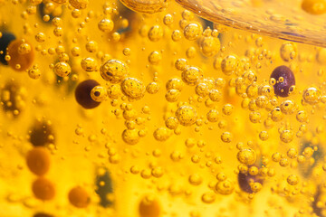 Serum, hair gel with bubbles and particles of a cleansing agent macro, front view. Cosmetic product in liquid state.