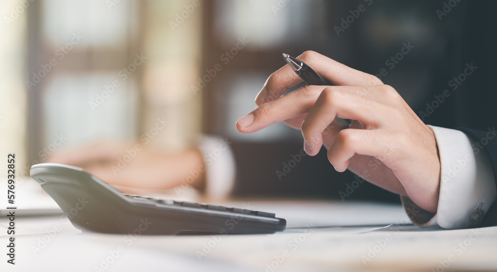 Poster businessman calculating figures in company financial documents with a calculator,analysis of company