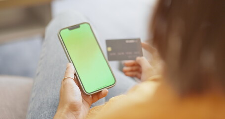 Top view, smartphone and woman with credit card, green screen and online payment in living room. Female, lady and cellphone for transactions, mockup and customer with budget, finance and banking app