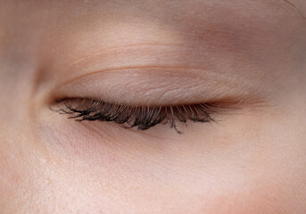 The closed eye of the girl.