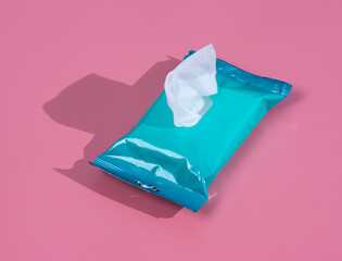 Open wet wipes flow pack on pink background,flat lay. Space for text - obrazy, fototapety, plakaty