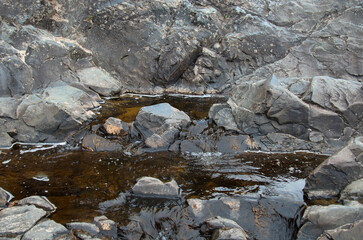 A small waterfall in a forest in a mountainous area