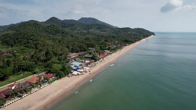 Forward reveal aerial footage of Lanta Klong Nin beach on sunny day. Ko Lanta, Krabi Province, Thailand.