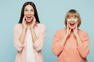 Elder parent mom with young adult daughter two women together wear casual clothes scream share hot...
