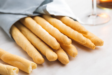 Italian grissini bread sticks on kitchen table.