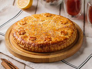 Top view on baked pie with beef and pumpkin filling